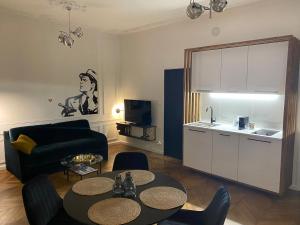 a living room with a couch and a table at La Cour in Nancy