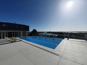 a swimming pool on top of a building with the ocean at Antique Barraca in Concepción del Uruguay