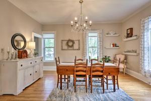 a dining room with a table and chairs and a chandelier at Bright Clear Lake Getaway, 4 Blocks to Downtown! in Clear Lake
