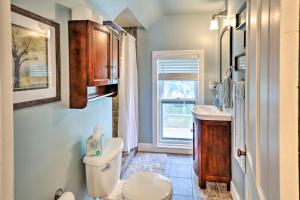 a bathroom with a toilet and a sink and a window at Bright Clear Lake Getaway, 4 Blocks to Downtown! in Clear Lake +25 photos