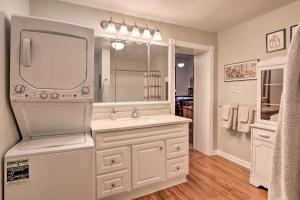 a bathroom with a sink and a large mirror at Renovated WV Schoolhouse History Buffs Heaven! in Kearneysville +16 photos