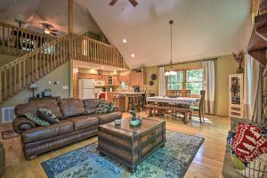 a living room with a couch and a table at Cacapon River Cabin with Private River Access! in Great Cacapon