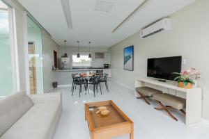 a living room with a couch and a table at Dunas House 97 - Santo Amaro in Santo Amaro