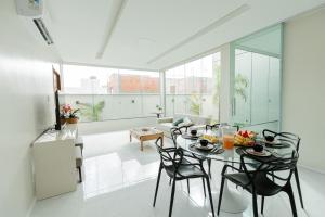 a kitchen and dining room with a table and chairs at Dunas House 97 - Santo Amaro in Santo Amaro