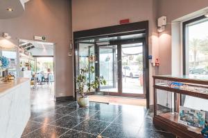 a restaurant with a lobby with a door open at Hotel Santa Maria in Chiavari