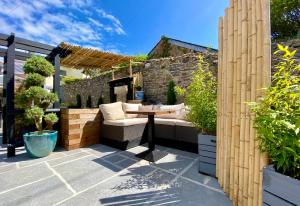an outdoor patio with a table and chairs at Brightham House - Exclusively for Adults in Salcombe