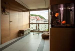 a room with a large window and a view of a building at Contemporary apartment with fireplace & terrace in Banská Bystrica
