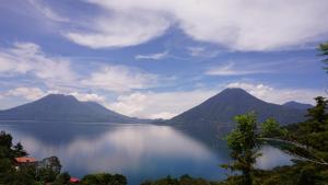 a view of a large body of water with mountains at EL PICNIC ATITL&Aacute;N in Tzunun&aacute;