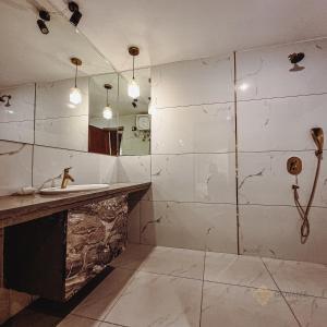 a bathroom with a sink and a shower at Giovanni House in Bhopal