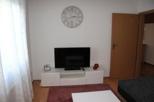 a living room with a flat screen tv on a white cabinet at Gemütliche City Wohnung - Im Herzen von Trier in Trier