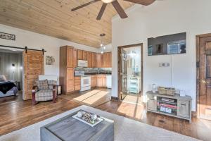 a living room with a ceiling fan and a kitchen at Pet-Friendly Retreat on a Horse Breeding Farm! in Keymar