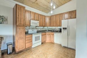 a kitchen with wooden cabinets and white appliances at Equestrian Escape! Quiet Farm Stay Near Gettysburg in Keymar +16 photos