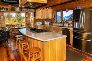 a kitchen with a large island in a cabin at Juneberry Lodge in Homer