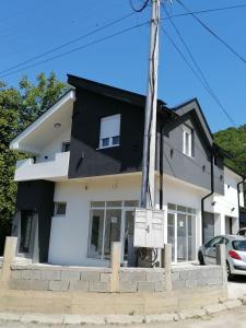 a white house with a black roof at Drobnjak apartments in Bijelo Polje