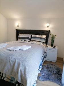 a bedroom with a large bed with two towels on it at Drobnjak apartments in Bijelo Polje