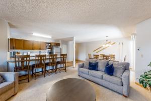 a living room with a couch and a table at Sawmill Creek 216 in Breckenridge