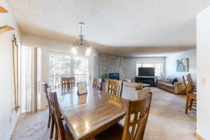 a dining room and living room with a wooden table at Sawmill Creek 216 in Breckenridge