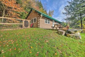 a log cabin with a fence and a yard at Cambridge Cabin Less Than 2 Mi to Smugglers Notch! in Jeffersonville