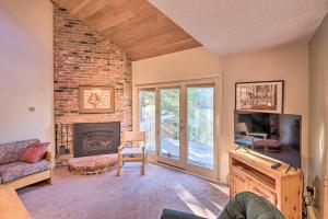 a living room with a fireplace and a tv at Charming Jackson Mountain Retreat on Golf Course! in Jackson