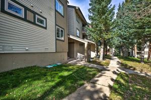 a house with a grass yard next to a driveway at Ski-InandSki-Out Breckenridge Condo Near Main St! in Breckenridge