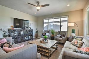a living room with couches and a table at Utah Home with Pool and Hot Tub Access, Mtn Views! in Santa Clara