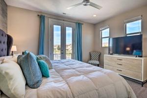 a bedroom with a large bed and a flat screen tv at Utah Home with Pool and Hot Tub Access, Mtn Views! in Santa Clara +35 photos