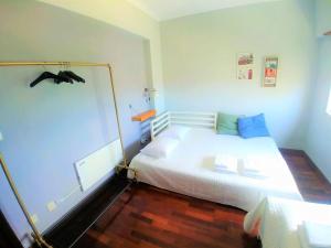 a bedroom with a white bed with blue pillows at Be Local - Apartment with 3 bedroom near Oriente Station in Lisbon in Lisbon