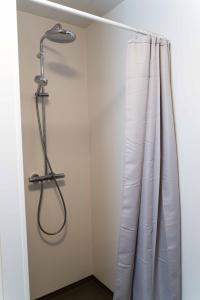 a shower in a bathroom with a shower curtain at Efri Bru in Selfoss