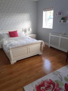 a bedroom with a white bed with a red pillow at Private Room in Superb House Bed 1 in Nobber