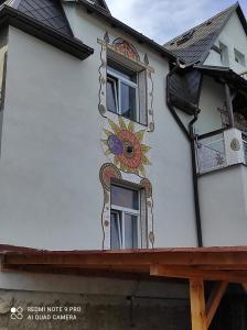a house with a painting on the side of it at art-house 4 Attic Apartment in Děčín