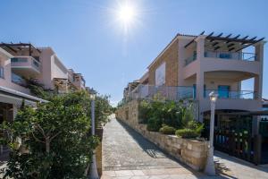 a street in front of some apartment buildings at Isida Hotel Agia Marina in Agia Marina Nea Kydonias