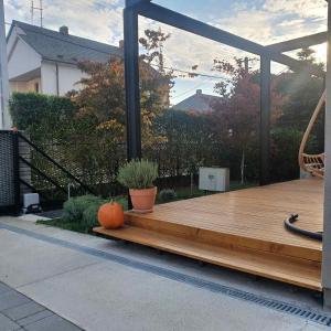 a wooden deck with a pumpkin sitting on it at MAXIM Apartments in Harkány