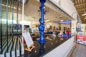 a blue vase on the counter of a store at Isida Hotel Agia Marina in Agia Marina Nea Kydonias