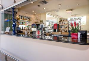 a bar at a restaurant with a counter at Isida Hotel Agia Marina in Agia Marina Nea Kydonias