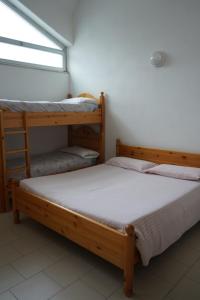 Postel nebo postele na pokoji v ubytování Rifugio Trifoglio Ass. Ostelli Lombardia