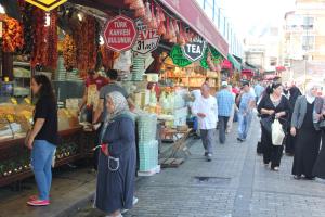 a group of people walking down a street in a market at Reydel Hotel in Istanbul