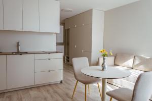 a kitchen and dining room with a table and chairs at Seaside bent in Juodkrantė