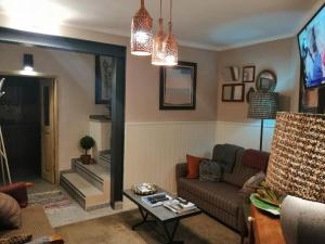 a living room with a couch and a table at Casa do Ti Messias in Almeida