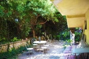Chambres d'hôtes Avignon في أفينيون: طاولة وكراسي في ساحة بها اشجار