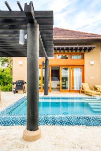 an image of a house with a swimming pool at Ileverde 21 - Private garden Bungalow in Punta Cana