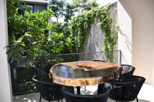 a wooden table sitting on top of a balcony at Kaab At The Park by The Spot Rentals in Playa del Carmen