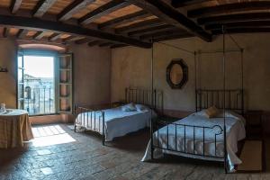 a bedroom with two beds and a large window at Villa Bottini ideale per relax di lusso in Robecco dʼOglio