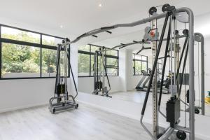 a gym with several tread machines in a room with windows at Lilly's Gold in Johannesburg