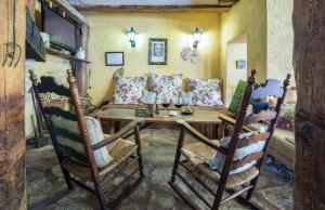 a living room with a wooden table and chairs at Casa Rural Garrido in Ademuz