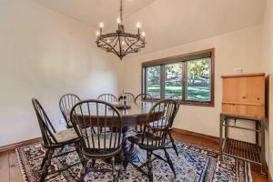 a dining room with a table and chairs and a chandelier at 10 N Fairway Drive in Beaver Creek
