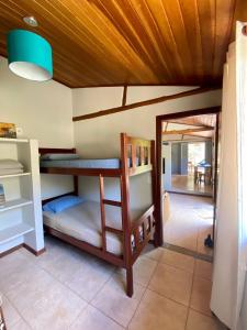 a room with two bunk beds and a doorway at Casa em Área Rural - Delfinópolis in Delfinópolis