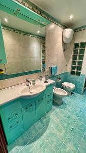 a bathroom with a sink and a toilet and a mirror at APPARTAMENTO AFRODITE in Tessennano +33 photos