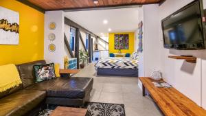 a living room with a couch and a tv at Carters Beach Seaside Accommodation in Carters Beach