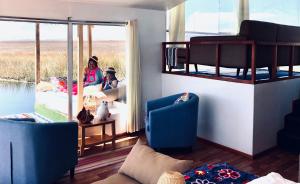 two women sitting in a living room with bunk beds at QHAPAQ Lago Titicaca - Perú in Puno
