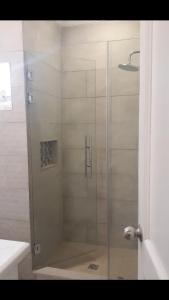 a shower with a glass door in a bathroom at Mirango Apartments in Boquete